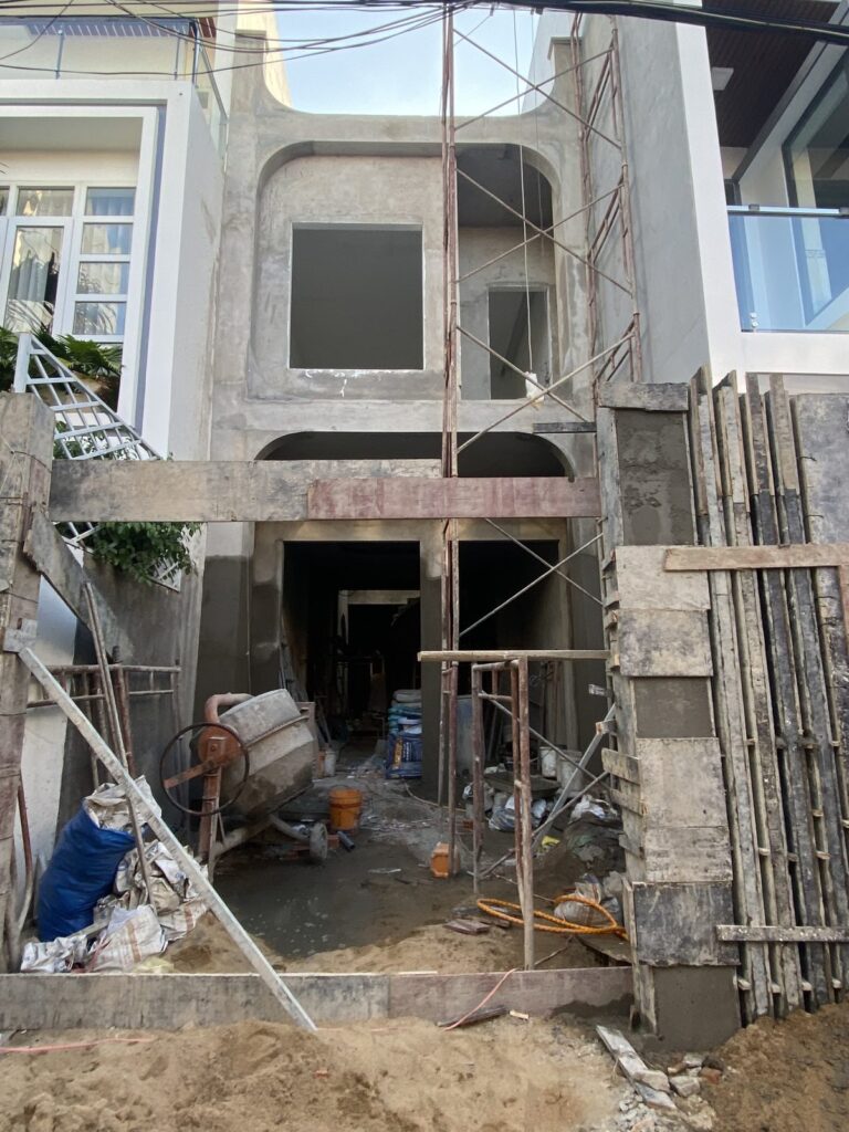 Nhà phố phần thô đã tô trát, cột chống và máy trộn còn tại chỗ